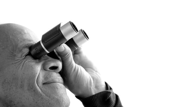 man looking through binoculars at a sport event with white background with people stock image stock photo	