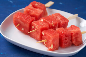 Finger food sticks with with watermelon cubes.