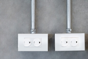 White safety outlet plug cover on the wall. Child electrical power socket outlet protector. Electricity protection equipment