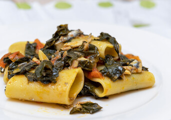 Paccheri with anchovies, black cabbage and cherry tomatoes.