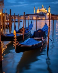 Two blue gondolas docked by calm water near cathedral at Venice