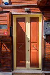 The front door is brown wood, in the old style.