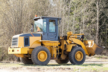 Tractor with bucket.The bulldozer is carrying out repair work.Construction works.