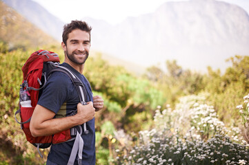 Hiking, happy and portrait of man on mountain for fitness, adventure and travel journey....