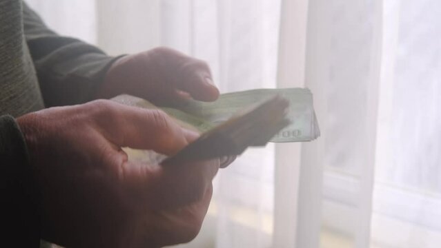 man holding, counts lot of national currency of Sri Lanka, paper money bills Rupee banknotes, devaluation, high inflation of state, exchange rate on travel, vacation, savings, banking, tax payment