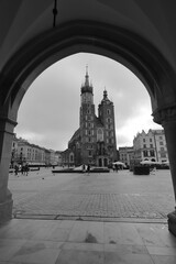 Black and White image of St Marys Basilica from the Arches of the Cloth Hall. Krakow, Poland, Europe.