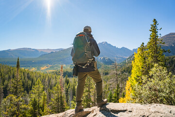 hiker in the rocky mountains on sunny day