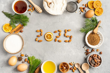 Frame of Ingredients for cooking Christmas baking and gingerbread cookies on a gray background, top...