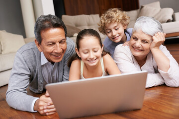 Laptop, relax or grandparents with happy kids for movie streaming online subscription in a family at home. Children siblings, floor or grandmother watching videos in retirement with a senior old man