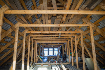 attic room with roof rafters of a wooden house