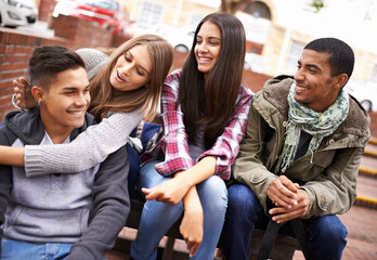 University, friends and people on campus in conversation, talking and chat outdoors on steps. Diversity, education and happy men and women students relax and bonding on school, academy and college