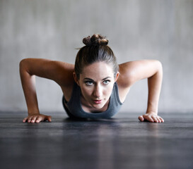 Fototapeta na wymiar Pushup, fitness and woman on a floor for training, cardio and endurance at gym. Push up, exercise and female athlete at a health center for core, strength and ground workout with determined mindset