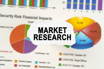 On diagrams and graphs lies torn paper with the inscription - Market Research