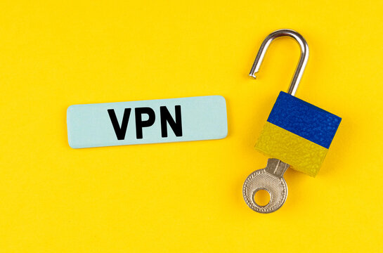 On the yellow surface is an open lock with a key and a sticker with the inscription - VPN - Powered by Adobe