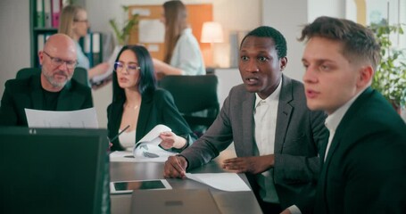Corporate employees during meeting in office discussing topics related to sales
