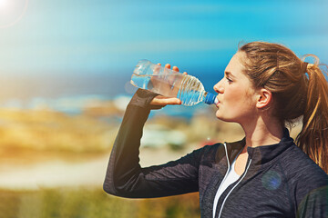 Woman drinking water, health and fitness in nature, blue sky and athlete outdoor with hydration and...