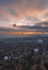 Hot air balloons flying during the sunrise in Cappadocia - Turkey