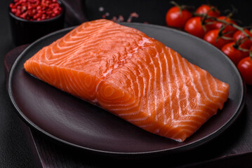 Fresh raw salmon red fish fillet with salt and spices