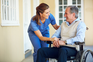 Speaking, happy caregiver or old man in wheelchair in hospital helping an elderly patient for...
