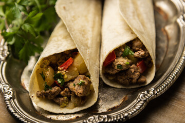 Flavor Fiesta: Close-Up of a Mouthwatering Taco Portion with Savory Meat and Colorful Vegetables