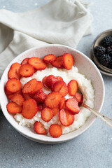 Rice porridge with milk and strawberries. A delicious homemade breakfast for the whole family. 