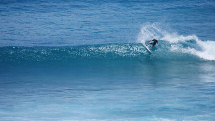 Man riding a wave doing a top turn in maui