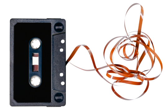 Old audio cassette with unrolled tape. Isolated background.