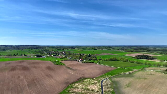 A drone view of the landscape of Warmia in the spring during field work, northern Poland, Europe
