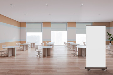Modern school classroom interior with empty white mock up poster, desks, wooden flooring, and window with city view. Education and auditorium concept. 3D Rendering.