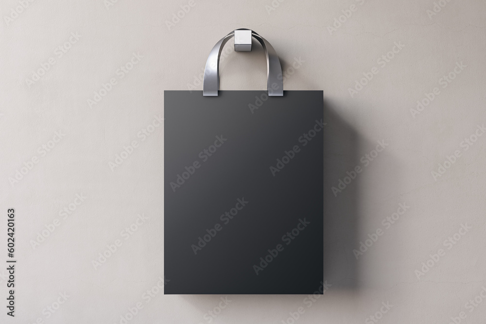 Aufkleber shopping or present concept with front view on blank dark craft bag with silver handles and space fo