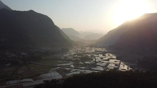 Aerial over stunning Mai Chau landscape patchwork rice paddy fields 
