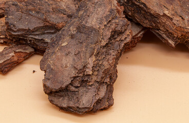 The texture of pine bark on a peach table.