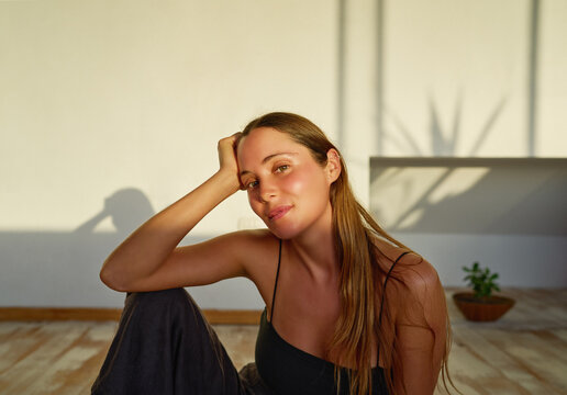 Beauty Portrait Young Caucasian Woman Sitting On The Floor Posing And Smiling  Carefree  Indoors	