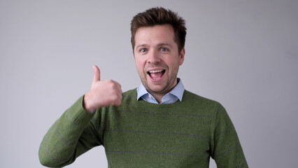 The European young man gives a thumbs up, approving the choice