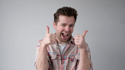 The European young man gives a thumbs up, approving the choice