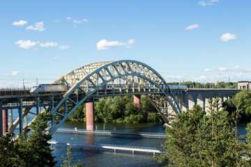 Obraz na płótnie Canvas Train crossing an arch bridge in Stockholm, Sweden