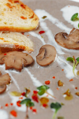Mushroom cream soup and ingredients on grey background, close up