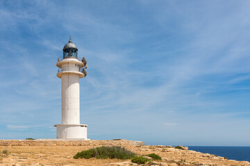 Fototapeta na wymiar Formentera: Cape Barbaria lighthouse at the edge of the cliffs and the Mediterranean Sea