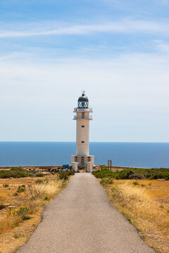 Formentera: Cape Barbaria lighthouse. Vertical photo with road leading to the lighthouse of Barbaria, on the island of Formentera (Balearic Islands, Spain).