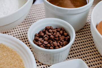 Chocolate in sprinkles and ingredients to prepare cake.