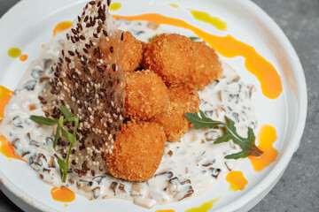 Potato croquettes - mashed potatoes balls breaded and deep fried, served with different sauce.