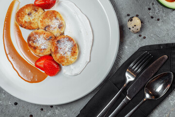 Sweet delicious food for breakfast. Pancake cheesecakes with fresh strawberry, blueberry and maple syrup. Delicious tasty pancake, morning food in cafe.