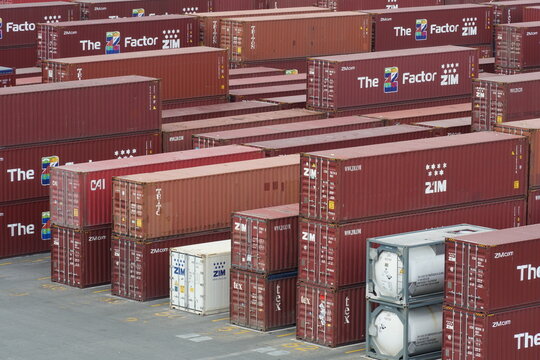 Kingston, Jamaica - 05 04 2023: Full red brown containers from ZIM shipper stowed in cargo terminal of Kingston port ready for loading on vessels. 