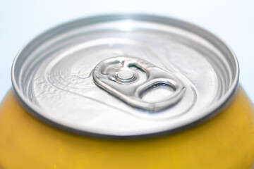 Closed beer can on a white background, yellow color.