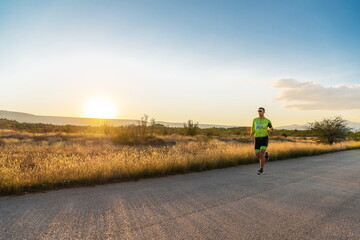 Obraz premium Triathlete in professional gear running early in the morning, preparing for a marathon, dedication to sport and readiness to take on the challenges of a marathon. 