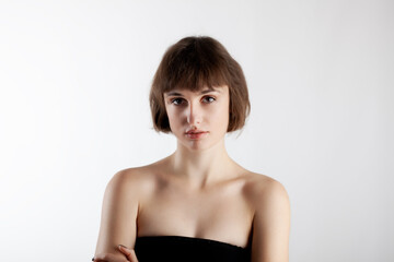 Fototapeta na wymiar studio portrait of a beautiful brunette girl with short hair isolated on white background.