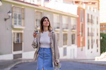 A beautiful lady taking pictures with a camera in the city 