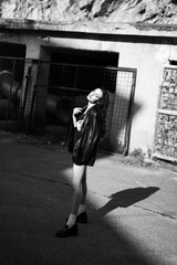 Black and white shot beautiful girl in jacket and shorts. girl with long legs