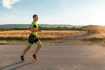 Triathlete in professional gear running early in the morning, preparing for a marathon, dedication to sport and readiness to take on the challenges of a marathon. 