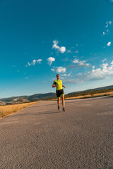 Obraz premium Triathlete in professional gear running early in the morning, preparing for a marathon, dedication to sport and readiness to take on the challenges of a marathon. 